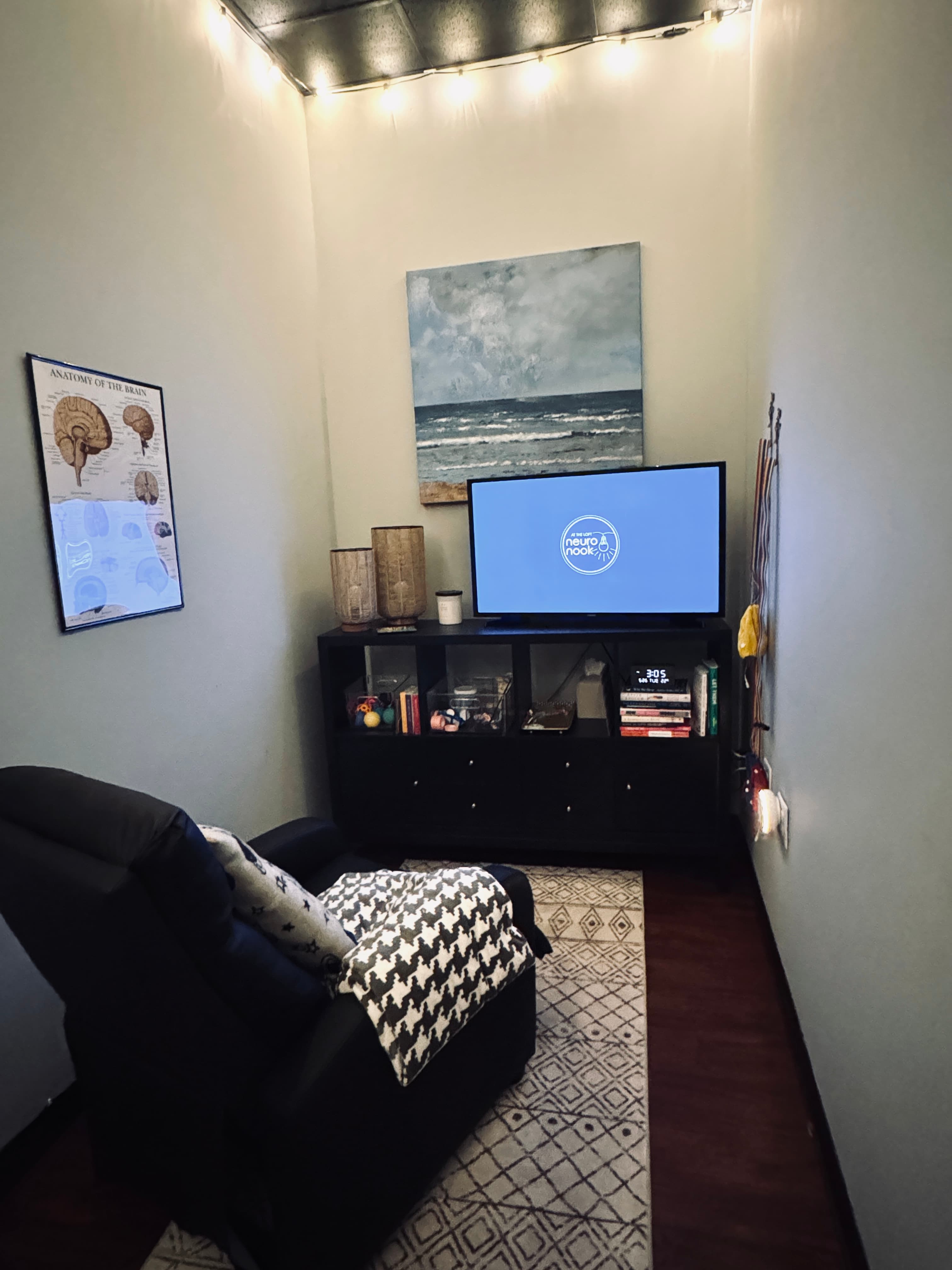 The NeuroNook room — a cozy recliner, fairy lights, and a TV