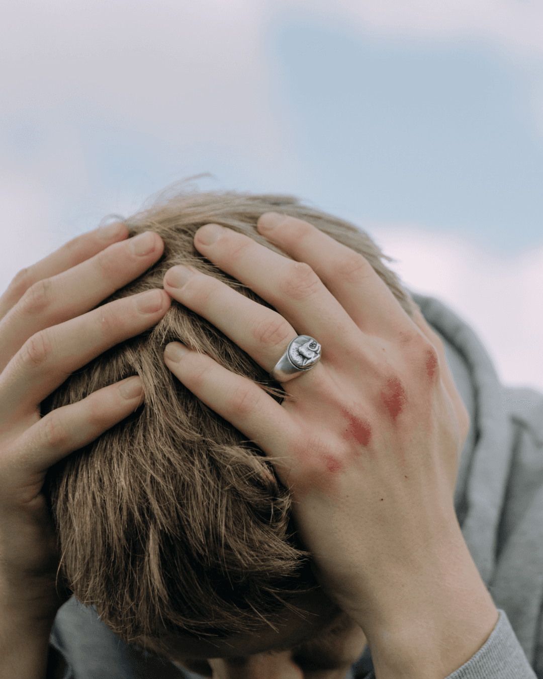 Person sitting alone, processing difficult emotions